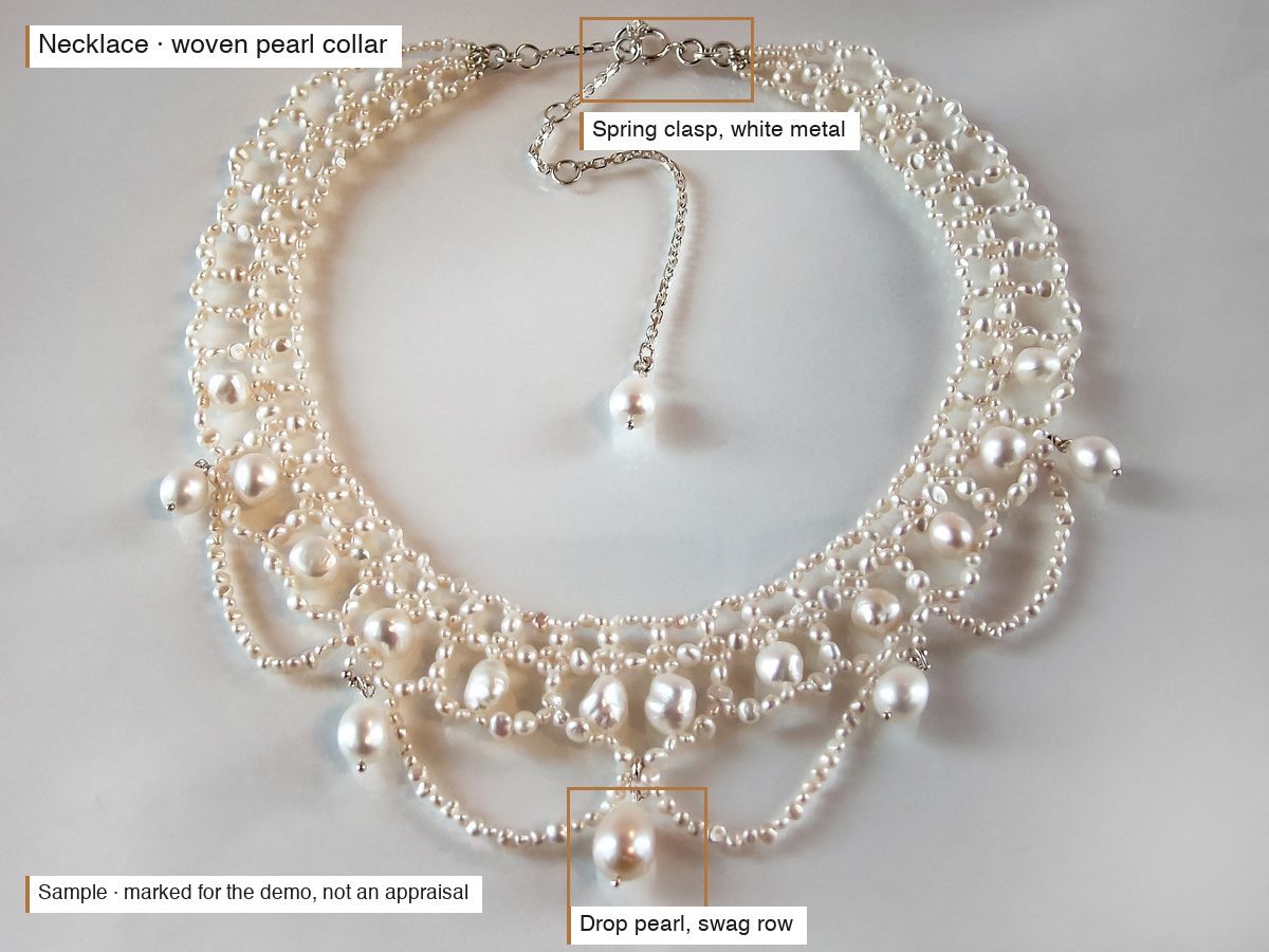 The same photo with the report's findings marked on it: the woven lattice body, the scalloped swags and hanging drop pearls, and the extension chain with its clasp and end pearl at the back